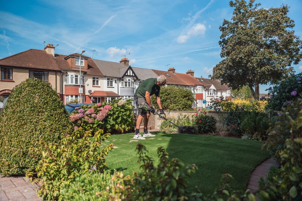 Applying finishing touches to artifical lawn 