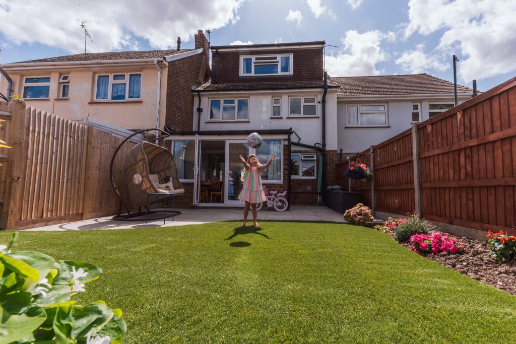 child playing on artificial lawn